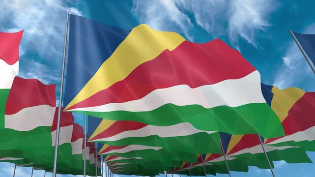 Multiple Seychelles flags seamless looping waving on blue sky