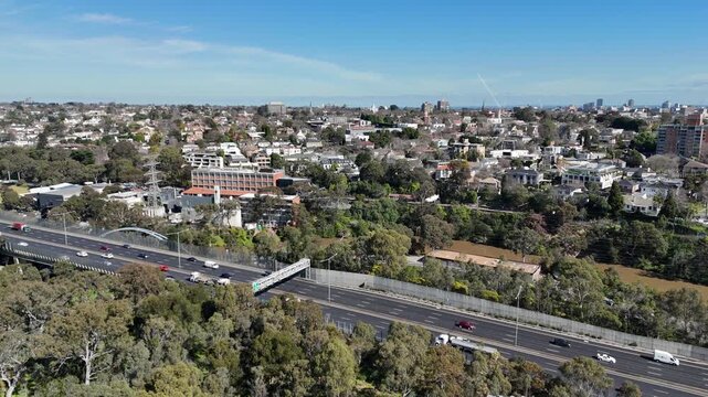 Aerial view of the M1 Monash Freeway traffic running alongside the Yarra River towards the affluent inner-city suburb of Toorak in Melbourne, Victoria, Australia. Urban highway infrastructure 