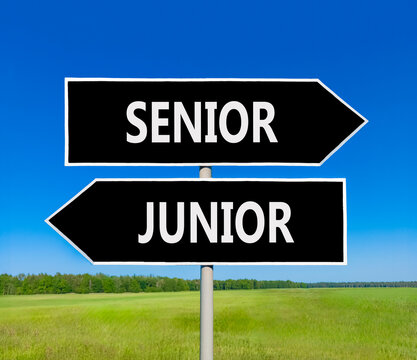 Senior or junior words symbol. Concept words Senior Junior on beautiful black road sign. Beautiful blue sky background. Business and senior or junior concept. Copy space.