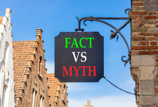 Fact vs versus myth words symbol. Concept words Fact vs Myth on beautiful black road sign. Beautiful blue sky Brugge street background. Business and fact vs versus myth concept. Copy space.