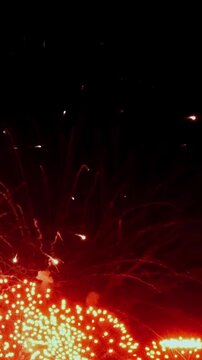 Experience mesmerizing display of bright sparks and colorful lights bursting into night air, creating electrifying atmosphere during local festival. Excitement is palpable and breathtaking.