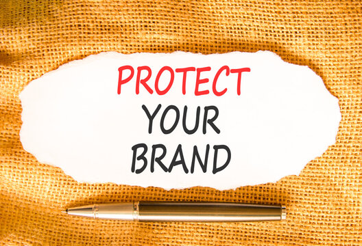 Protect your brand words symbol. Concept words Protect your brand on beautiful white paper. Beautiful canvas background. Black pen. Business and protect your brand concept. Copy space.