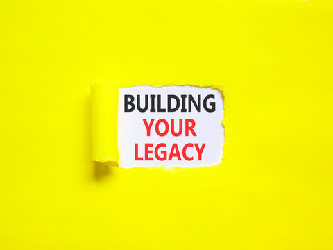 Building your legacy words symbol. Concept words Building your legacy on beautiful white paper. Beautiful yellow background. Business building your legacy concept. Copy space.