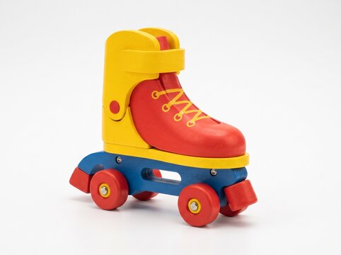 Fully Painted Wooden Toy Rollerblades in White Background