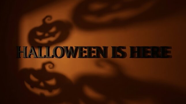 Dark moody background with carved jack o lantern pumpkins and the text halloween is here written