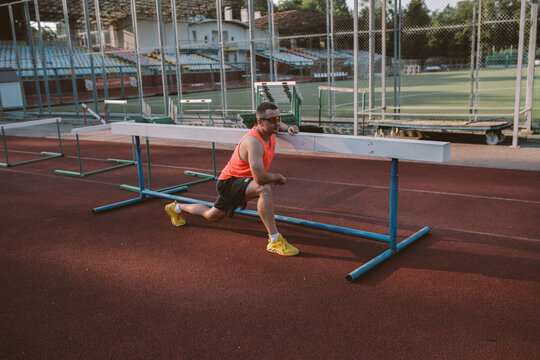 Male athlete training alone at outdoor sports stadium