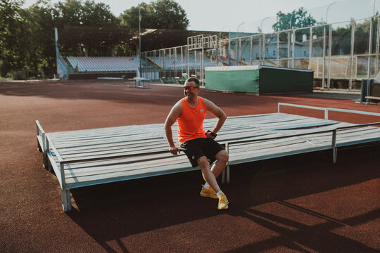 Male athlete training alone at outdoor sports stadium