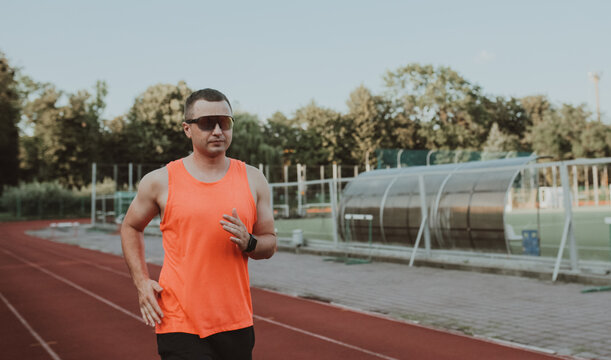 Male athlete training alone at outdoor sports stadium