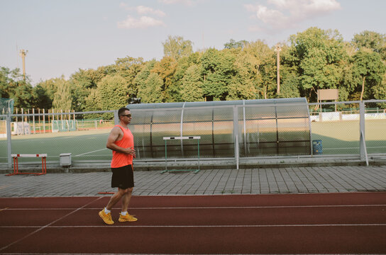 Male athlete training alone at outdoor sports stadium