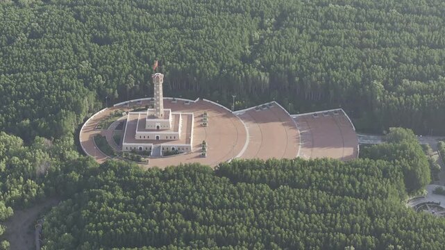 Aerial drone view of Mui Ca Mau National Park in Dat Mui, Ca Mau, Vietnam, featuring the national flagpole and coordinate marker surrounded by sunlit mangrove forests.
