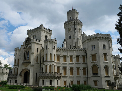 Beautiful travel stock photo of historic Hluboka chateau exterior. Impressive neo-gothic architecture with towers and decorative archway for travel website banner presentation.