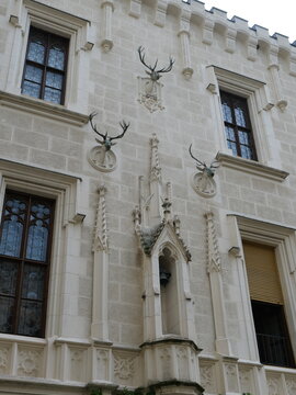 Beautiful travel stock photo of historic Hluboka castle exterior detail. Iconic hunting decor and neo-gothic architectural elements in South Bohemia for travel website layout.