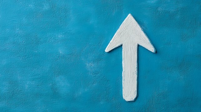 A white upward arrow painted on a textured blue background points towards the top, symbolizing growth, progress, or success