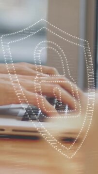 Animation of padlock icon and light trails over hands using laptop