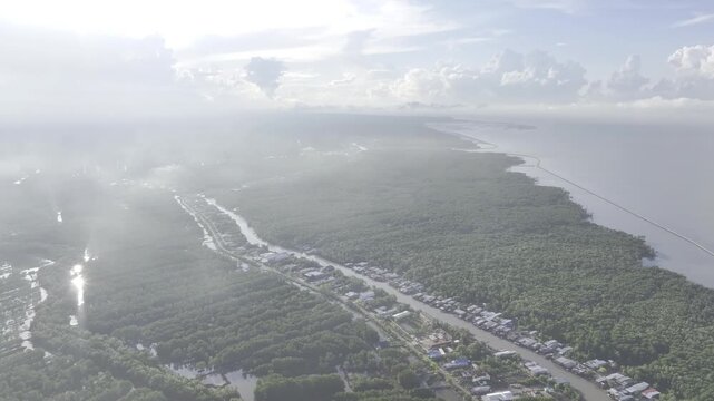 Aerial drone view of Mui Ca Mau National Park in Dat Mui, Ca Mau, Vietnam, featuring the national flagpole and coordinate marker surrounded by sunlit mangrove forests.
