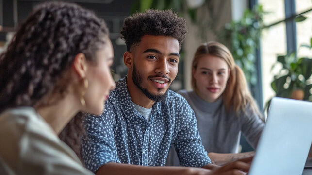 Close-up of young Gen Z professionals collaborating around a laptop in a casual modern workplace, authentic expressions, creative teamwork, future of work, realistic stock photogra