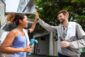 Naklejka premium Joyful post-workout high-five moment photo