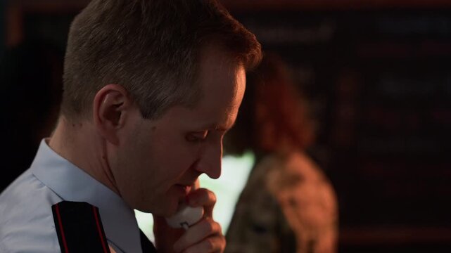 Middle aged Caucasian male military officer holding top secret document and talking on telephone in command center. Footage is perfect for historical documentaries and national security concepts