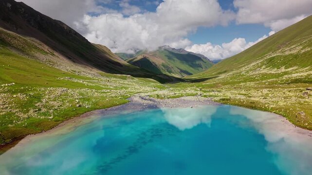 Aerial view of a turquoise alpine lake in mountains
