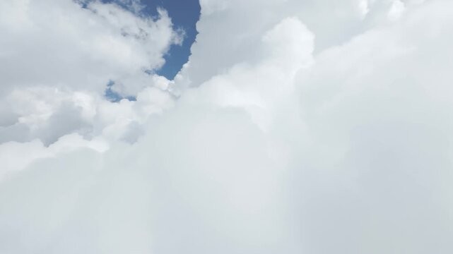 Camera moving forward through white cumulus clouds