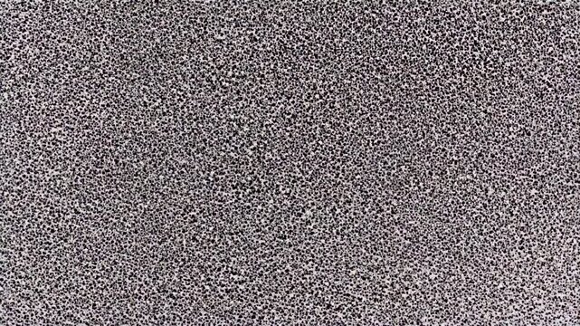 Gritty black texture background, close-up loop seamless, grainy rough