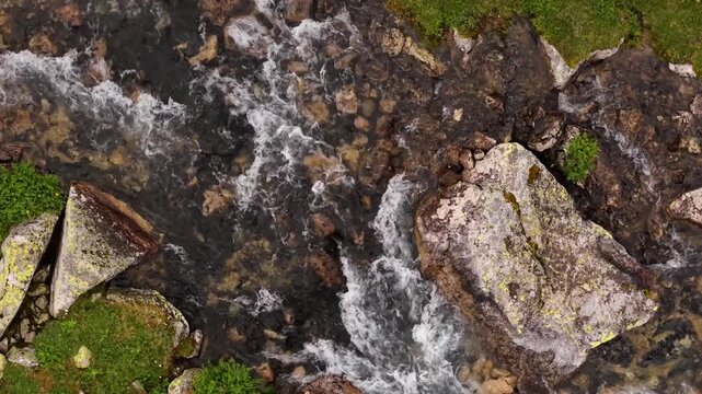 Rapid mountain stream flowing over rocky riverbed