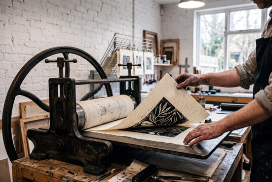 Vintage wooden printing press in an art studio, artisan printer operating antique machinery, woodblock printing process, traditional craft workshop background