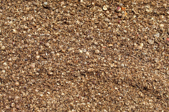 Coarsely ground coriander forms a natural brownish background texture pattern