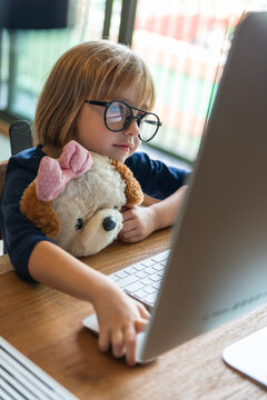 Child engaged with computer screen.