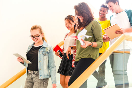 Students happily walking down stairs.