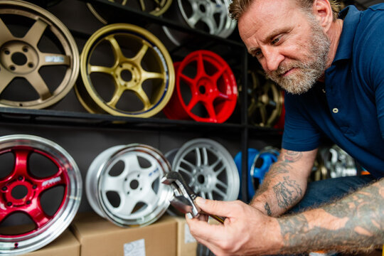 Man inspecting alloy wheels display