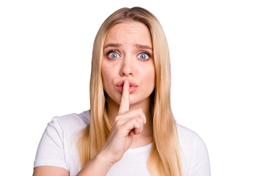 Close up photo beautiful amazing pretty her she lady hand arm index finger lips mouth terrified eyes full fear please do not say tell speak talk word wear casual white t-shirt isolated grey background