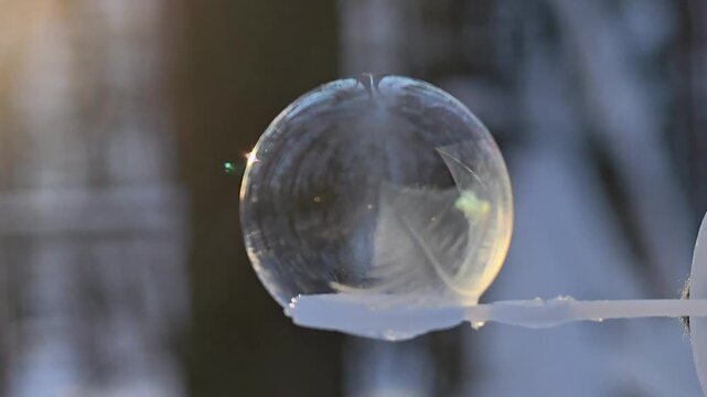 A blurred background of frost patterns forming on a soap bubble in winter, slow motion
