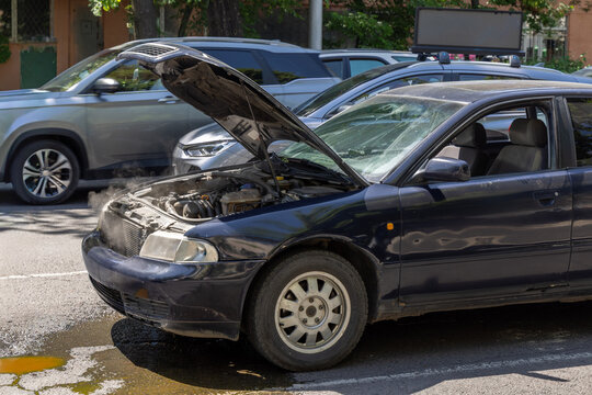 Dark Blue Sedan with Open Hood and Steam Rising