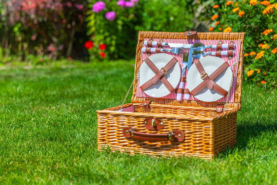 Picnic basket with copy space on green sunny lawn in the park