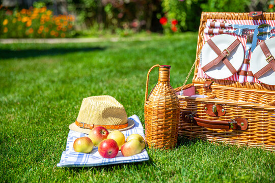 Picnic basket on green sunny lawn in the park