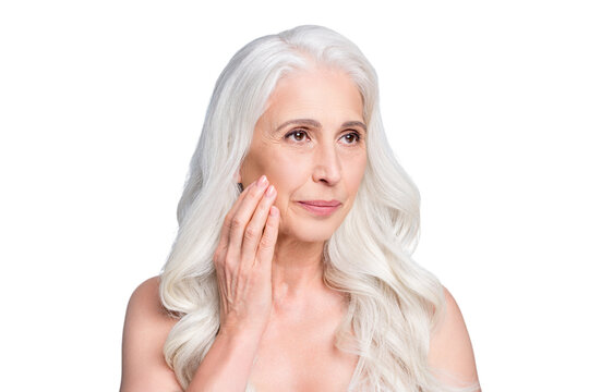 Close-up portrait of her she nice attractive healthy grey-haired elderly nude naked lady touching cheek isolated on light gray pastel color background