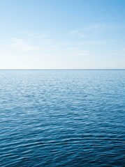 Fototapeta premium Serene Ocean Waves Rippling Under a Clear Blue Sky with a Distant Horizon Line Minimalist Seascape