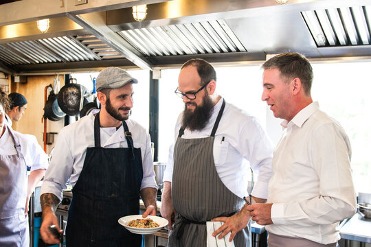 Chefs discussing dish preparation photo