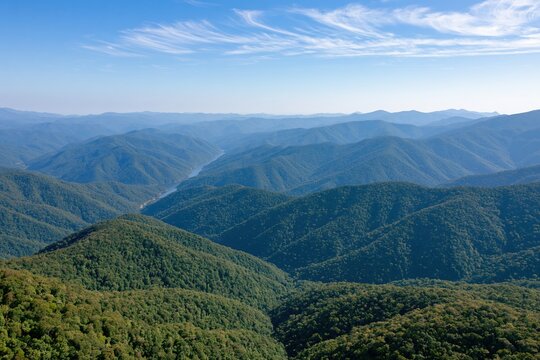 The Mountains of rolling green ridges and expansive valley landscapes under blue sky