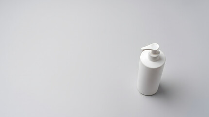 White cosmetic pump bottle standing upright viewed from above dispenser © ChaohM