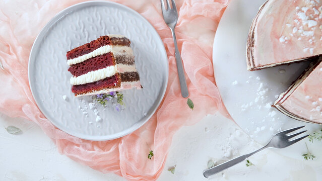 Slice of layered cake with cream on a plate