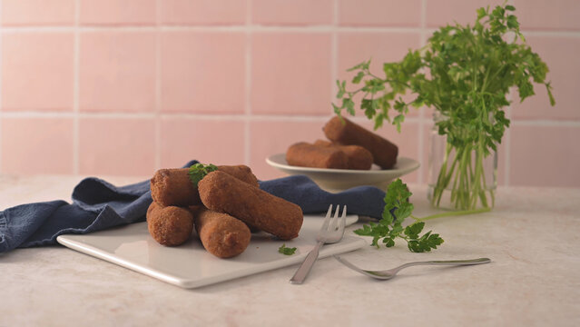 Crispy fried croquettes on a white plate