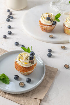 Blueberry cupcake with white frosting on a plate