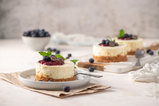 Mini cheesecakes with blueberry topping on a plate
