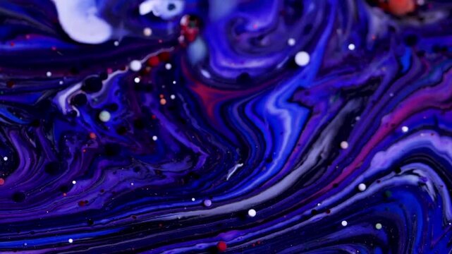 The abstract artistic beauty of blended, colorful fluids (liquid art). Swirls of dark blue, purple, and white are visible, intermingling to resemble a galaxy or a nebula in outer space.