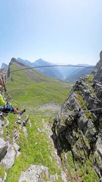 Climber standing on a suspended cable bridge on Via Ferrata di Cimalegna. Alagna, mountain adventure stock footage