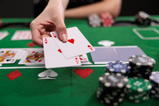 woman playing blackjack at the table with AA cards