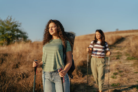 Two women hiking outdoors on a rural path