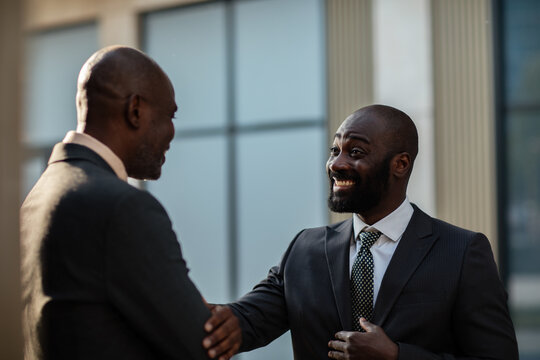Two businessmen greeting outside office building